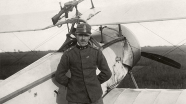 Baracca poses in front of his Nieuport 11 in Santa Caterina di Udine. The Lewis machine gun is clearly visible on the upper wing of the aircraft